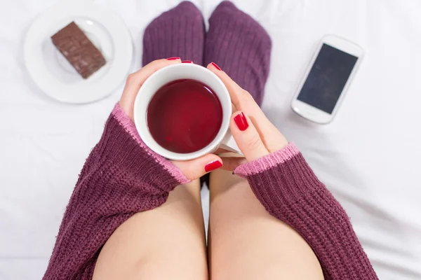 Donna che beve una tazza di tè a letto — Foto Stock