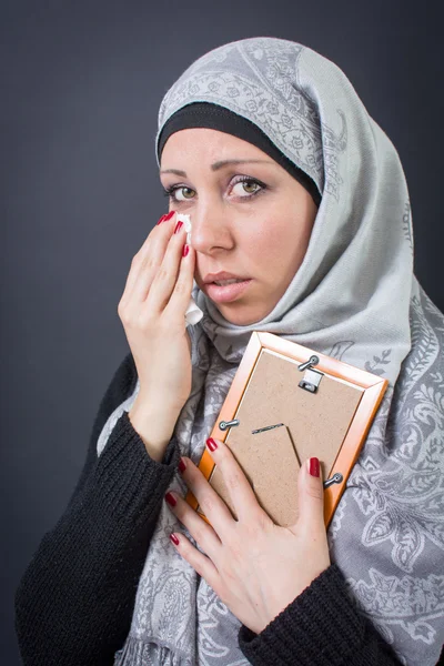 Мусульманская женщина стонет над фотографией — стоковое фото