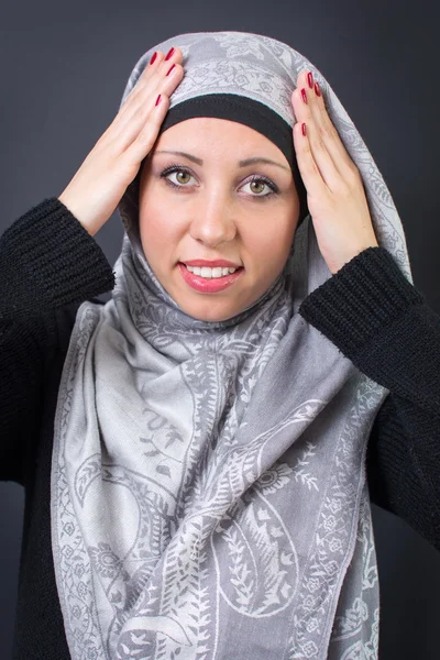 Muslim woman adjusting her headscarf — Stock Photo, Image