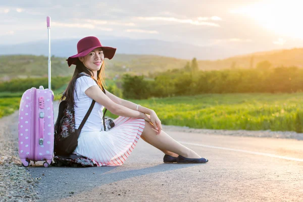 Menina solitária sentada na estrada — Fotografia de Stock