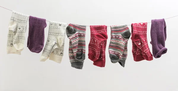 Various socks hanging on a wire — Stock Photo, Image