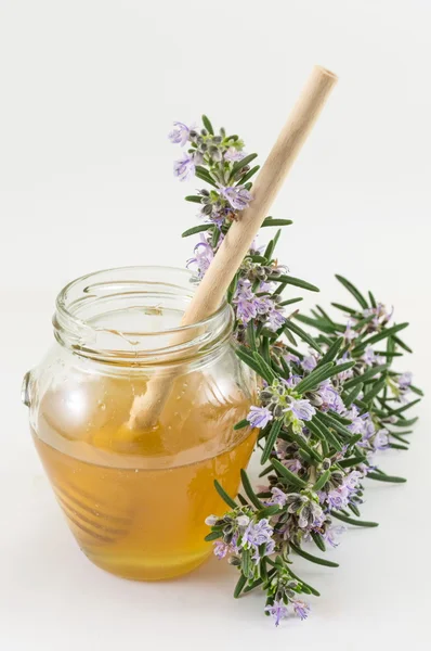 Свіжі квіти і баночка з медом — стокове фото
