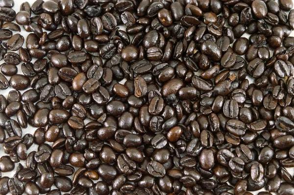 Bunch of Roasted coffee beans forming background — Stock Photo, Image