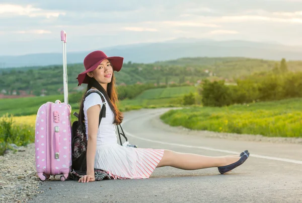 Menina solitária sentada na estrada — Fotografia de Stock