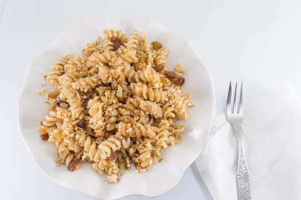 Sweet pasta with honey, nuts and raisins