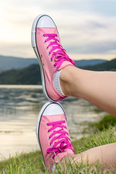 Enjoying by lake. Woman wearing pink sneakers — Stock Photo, Image