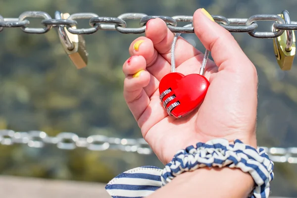 Woman hand holding heart shaped padlock — Stock Photo, Image