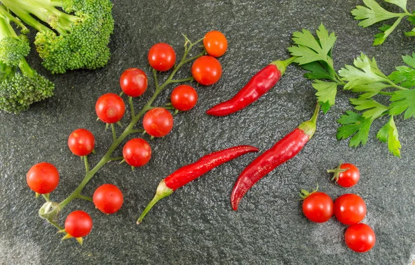 Cherry tomato and red pepper on stone background — Stock Photo, Image