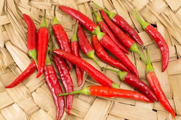 Fresh red peppers on wooden background — Stock Photo, Image