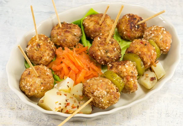 Meatballs on sticks decorated with vegetables — Stock Photo, Image