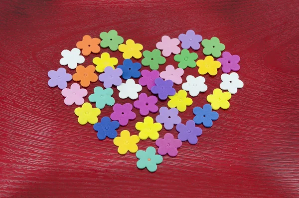 Heart made out of colorful paper flowers — Stock Photo, Image