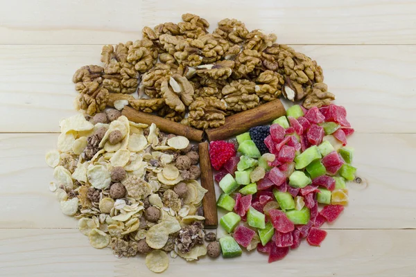 Muesli, walnuts and dried fruit on arranged a table — Stock Photo, Image