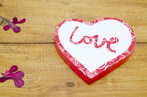 Heart shaped box on a wooden table — Stock Photo, Image