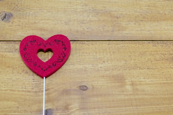 Red engraved heart on a table — Stock Photo, Image