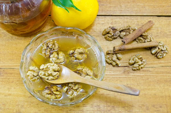 Walnuts honey and lemon on a table — Stock Photo, Image