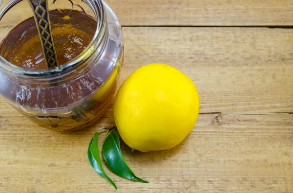 Whole lemon and honey in a jar — Stock Photo, Image