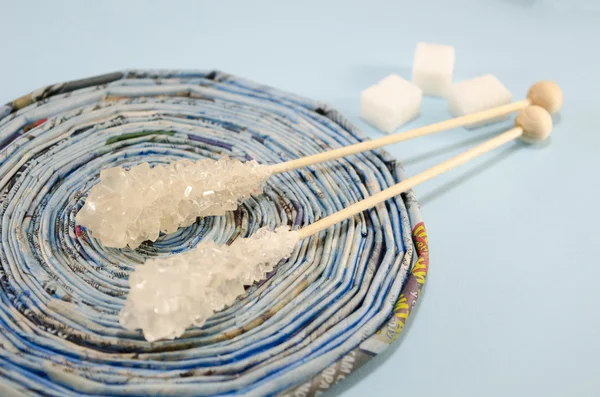 Dos palitos de azúcar en una mesa azul — Foto de Stock
