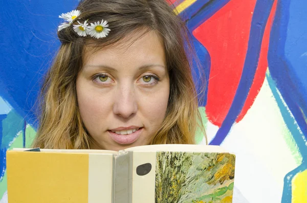 Beautiful brunette holding a book — Stock Photo, Image