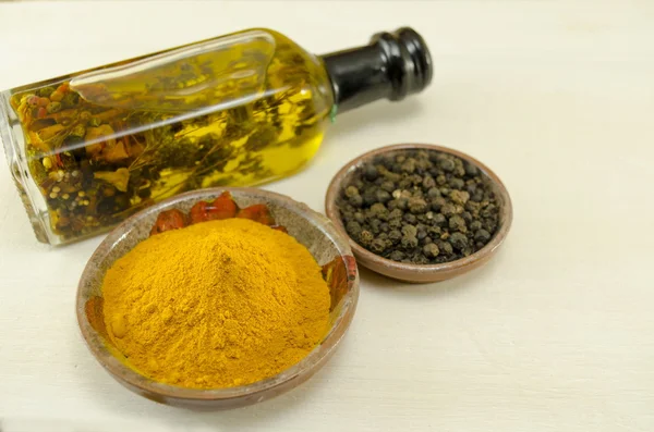 Curry , pepper and olive oil on a table — Stock Photo, Image