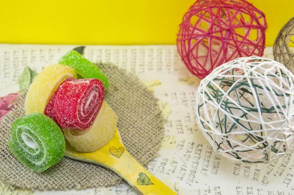 Coloridos rollos de gelatina en una cuchara de madera decoupage —  Fotos de Stock