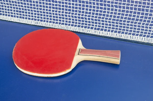 Table tennis paddle and net on a table — Φωτογραφία Αρχείου