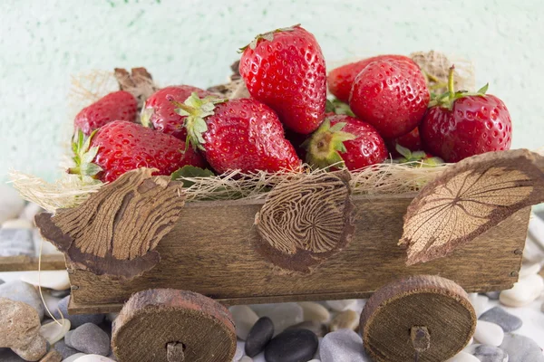 Strawberries on miniature old carts — Stock Photo, Image