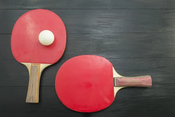 Two red table tennis rackets on dark background — Stock Photo, Image