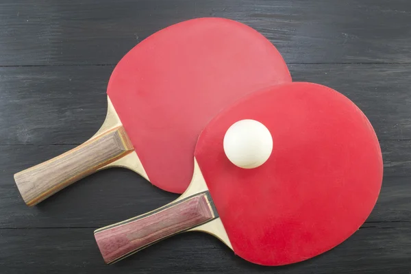 Two red table tennis paddles on dark background — Stock Photo, Image