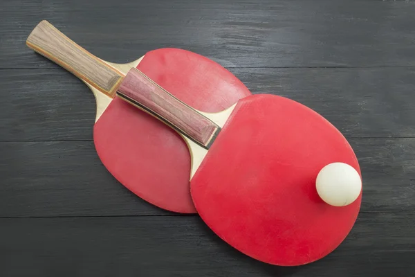 Two red table tennis rackets on dark background — Stock Photo, Image