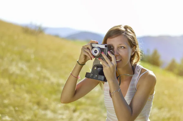 Молодая и красивая женщина с ретро-камерой — стоковое фото