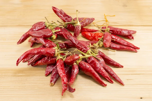 Fresh red peppers on a wooden table — Stock Photo, Image