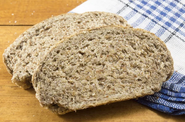 Home baked integral bread slices on the table — Stock Photo, Image