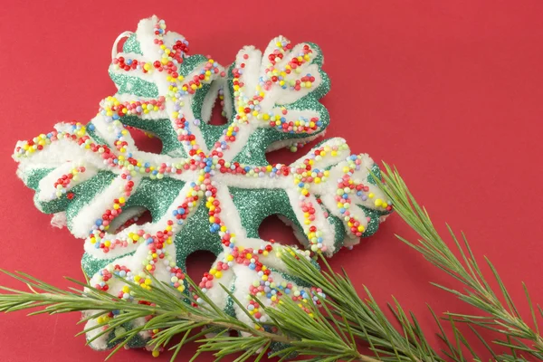 Star shaped Cristmas decoratoin on  a fir branch — Stock Photo, Image