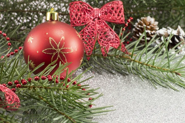Christmas ornament and fir tree on shiny background — Stock Photo, Image
