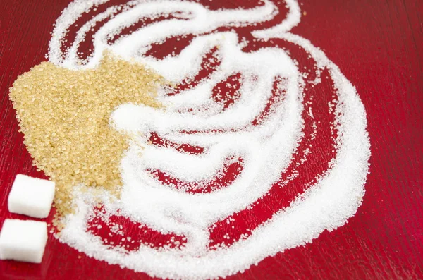 Azúcar blanco y moreno sobre fondo rojo — Foto de Stock