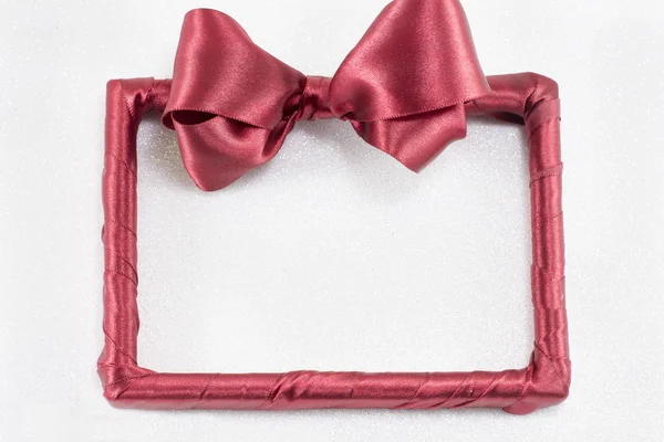 Empty picture frame with red ribbon — Stock Photo, Image