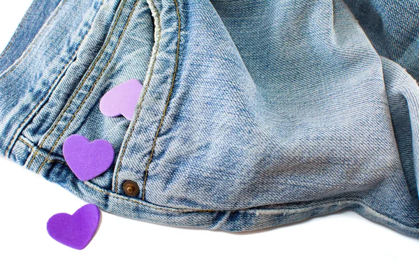 Purple hearts falling out of jeans pocket — Stock Photo, Image