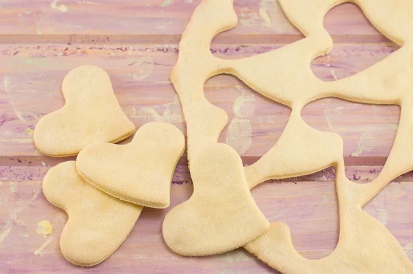 Dough with hearts cut out — Stock Photo, Image