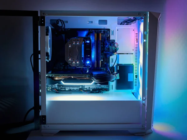 Gaming PC and CPU cooling fan with backlight. Desktop gaming computer with RGB led light inside. Concept of eSports and gaming.