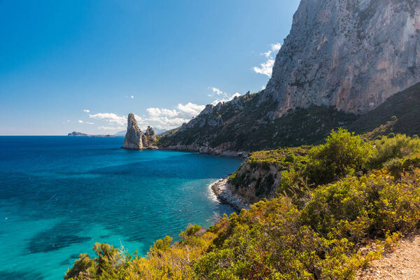 Coastline near Santa Maria Navarrese with rock pinnacle called Pedra Longa in the background (Sardinia, Italy)