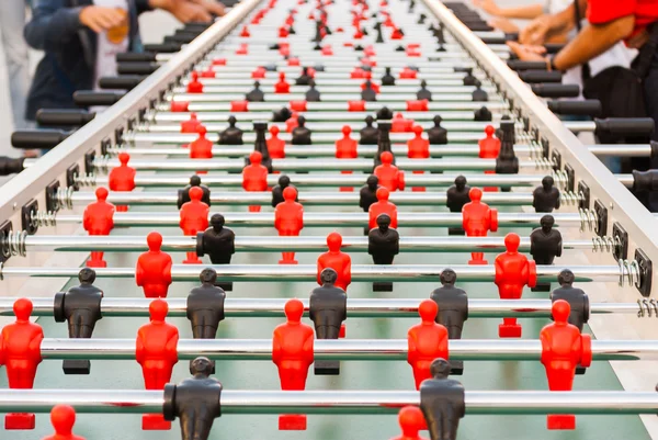 Strange table football with black and red players