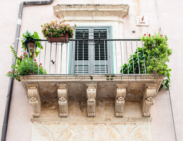 Balcony with baroque decorations in a house of Noto (Sicily)