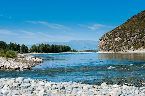 Wide blue river flows in the mountains — Stock Photo, Image