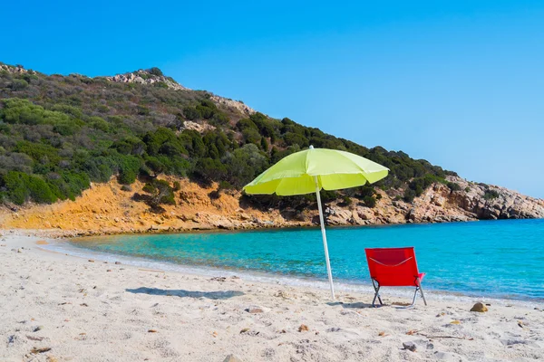 Beach umbrella and lounge chair — Stock Photo, Image