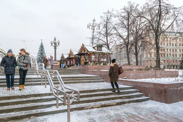 Pessoas nas escadas cobertas de neve perto da Praça Pushkin no Ano Novo — Fotografia de Stock