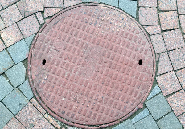 Textured metal manhole cover with holes — Stock Photo, Image