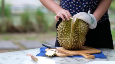 Yakın plan kadın eli soyan Durian, meyvelerin kralı