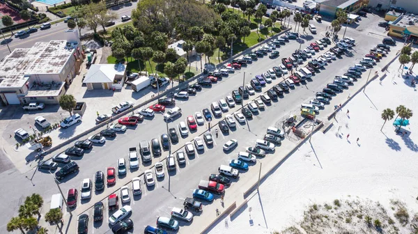 Public Parking for cars on the beach. Parking lot for car. Ocean beach Parking is full. Spring break or Summer vacations in Florida. Sunny day. Aerial top view.