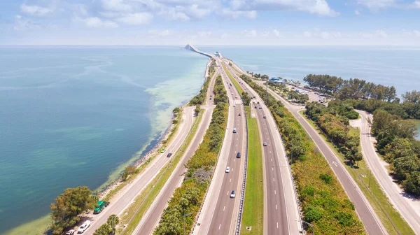 Highway or Freeway road. Ocean or Gulf of Mexico. Road for cars and truck. Low traffic on the way. Highway for any transportation. The Best American roads for travels. Skyway bridge. Aerial view