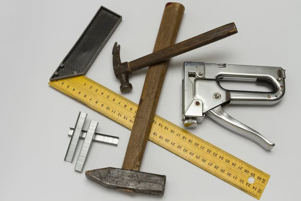 Hammer, gon, stapler and staples to him on a white background. — Stock Photo, Image